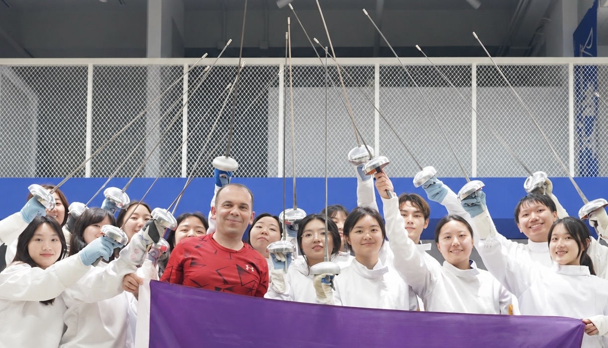 Coach Yousef Alaghehband leading a school fencing training session with students